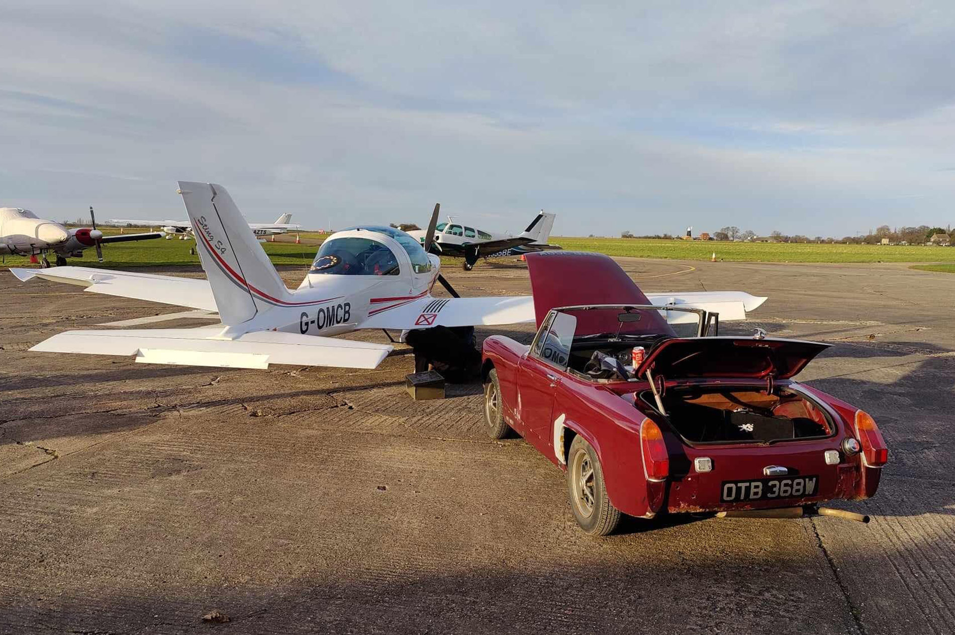 Classic car next to an aeroplane